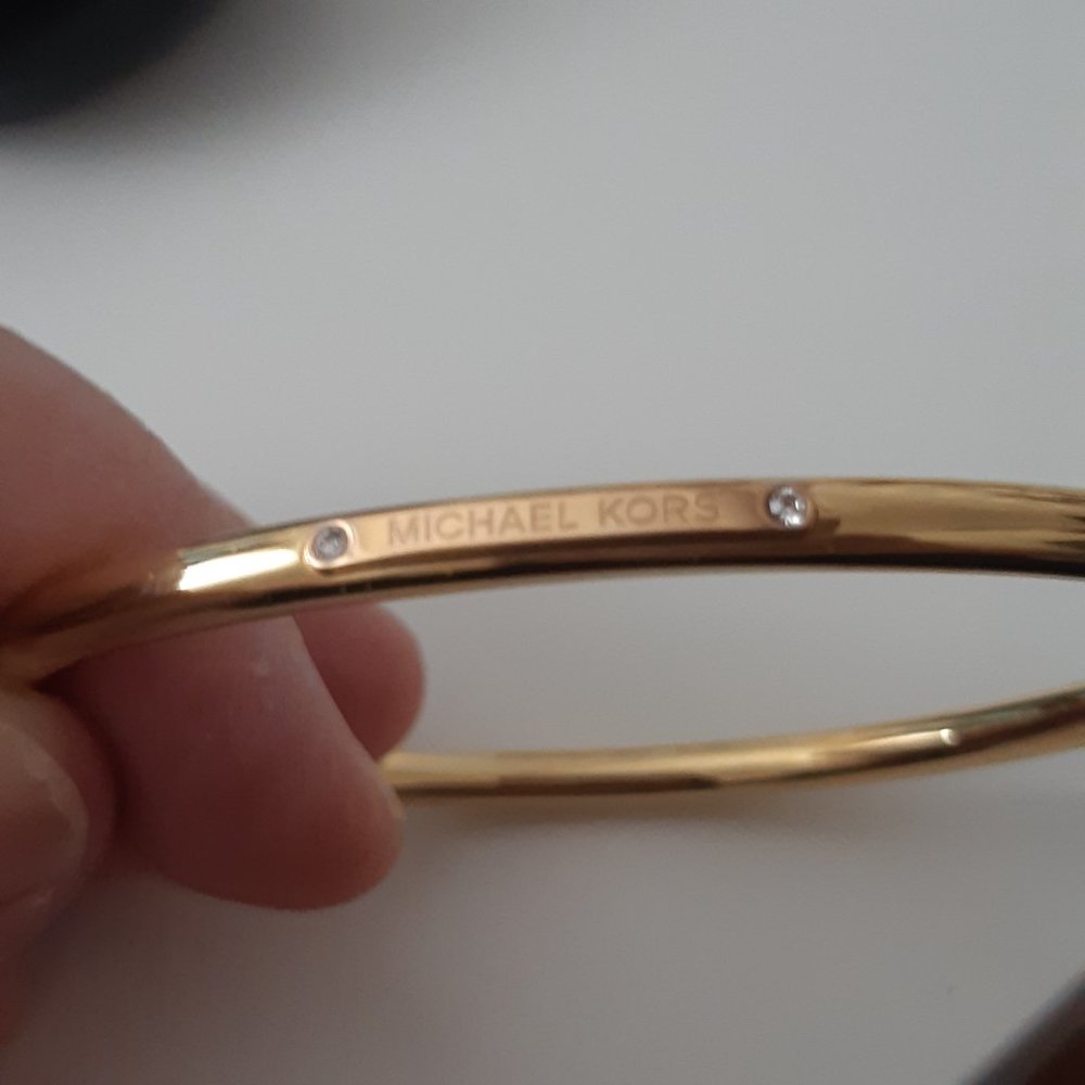 Michael Kors gold tone bangle bracelet.